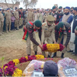 Lieutenant Colonel Aamir Rajefar is laying a wreath on behalf of the President of Pakistan at the grave of Naik Muhammad Usman, who was martyred by terrorists in the Express incident
