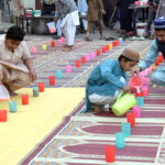 Volunteers distributing food among fasting people during an Iftar at Badshahi Mosque