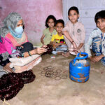 A worker woman joints bangles with the help of cylinder gas at her home to earn for livelihood in connection with International Women’s Day