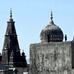 Youngsters flying kites despite ban from the roof top of their house in the city