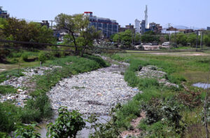 A view of garbage accumulated in the nullah near Expressway, obstructing the water flow and posing a risk of flooding, an issue that requires urgent attention and cleanup by the concerned authorities.
