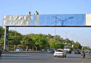 IESCO workers busy installed new electric wires on electric pole at IJP Road