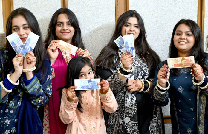 Girls happy to show their Eidi (Eid gifts) given by their elders during family get together on the third day of Eid Al-Fitr celebrations