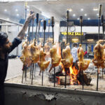 A worker busy in preparing the sajji for the customers at local restaurant