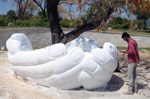 A stunning view of the hand-shaped model encircling a tree along Srinagar Highway, constructed by the Capital Development Authority (CDA) to enhance the beauty of the Federal Capital.