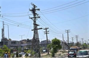 IESCO workers busy installed new electric wires on electric pole at IJP Road