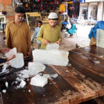 People purchasing the ice pieces from vendor at bacha khan chowk