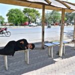 A person taking nap on bench at Aabpara Bus Stop in the Federal Capital