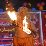 An artist shows his skills during a performance on the stage in Eid Function at Shaheed Zulfikar Ali Bhutto Open Air Theater Arts Council on the late night of 2nd day of Eid-ul-Fitr celebrations