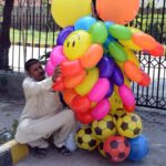 A street vendor displaying air filled toys to attract the customers