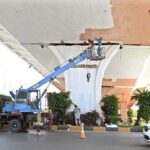 Labourers are busy paint the bridge at Peshawar Morr Interchange in the Federal Capital