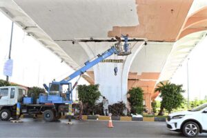 Labourers are busy paint the bridge at Peshawar Morr Interchange in the Federal Capital