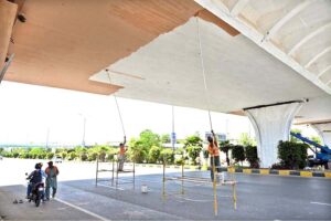 Labourers are busy paint the bridge at Peshawar Morr Interchange in the Federal Capital