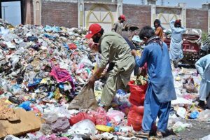 Gypsy youngsters search and collect valuables from a garbage heap along Lehtrar Road in the federal capital to earn their livelihood