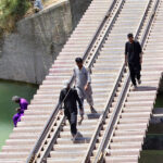 People passing through railway bridge over water canal at Tando Yousuf area