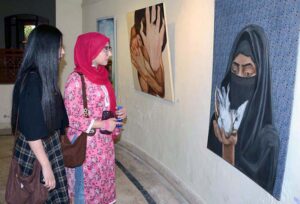 Students take keen interest in a painting while visiting the Lyallpur Art Festival at Faisalabad Arts Council