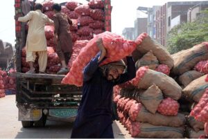 Labourer unloading onion from the delivery truck at Vegetable Market as the world marks 1st May as International Workers’ Day also known as Labour Day