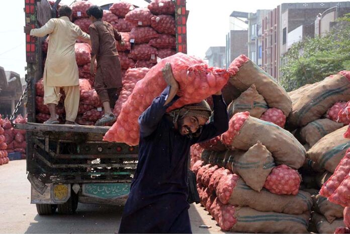 Labourer unloading onion from the delivery truck at Vegetable Market as the world marks 1st May as International Workers’ Day also known as Labour Day