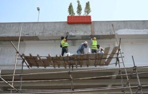 Labourers busy painting work on flyover to enhance beatification work in the City.