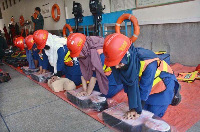 Female students participate in a life-saving drill during a flood mock exercise at Central Rescue Station, GTS Chowk, under the supervision of officers and representatives from Civil Defense, PDMA, Education, and Livestock departments