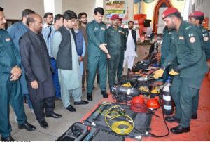 , Female students participate in a life-saving drill during a flood mock exercise at Central Rescue Station, GTS Chowk, under the supervision of officers and representatives from Civil Defense, PDMA, Education, and Livestock departments