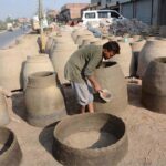 Labourer busy in preparing traditional clay oven (tandoor) at his workplace as the world marks International Labour Day. May 1st, International Workers’ Day, commemorates the historic struggle of working people throughout the world. In 1884, the Federation of Organized Trades and Labour Unions passed a resolution stating that eight hours would constitute a legal day’s work from and after May 1, 1886