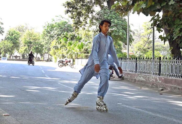 A youngster is enjoying skating in the Company Bagh