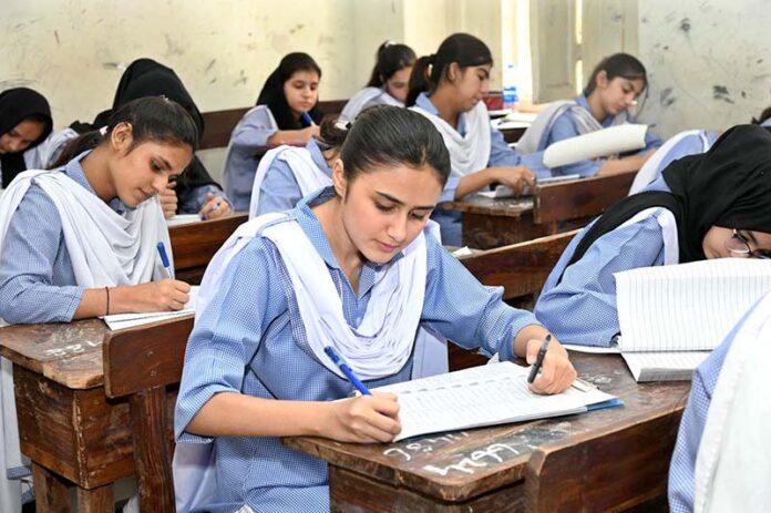 Students solving question paper during annual examination of SSC (part-I) 9th class at Government Girls Model School