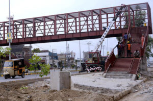 Workers are busy constructing a new pedestrian bridge on Walton Road.