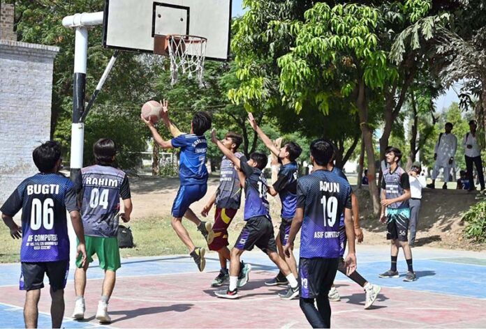 A beautiful moment as players attempt to score during the basketball match between Mass Communication and IT departments at the Sports Gala held at the University of Sargodha