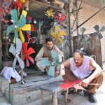 A mechanic is making room cooler fans at workplace in the city