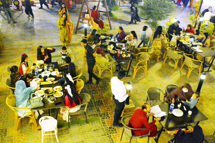 A view of large numbers of families celebrating the 3rd day of Eid-ul-fitr at a local restaurant on Jamshoro Road