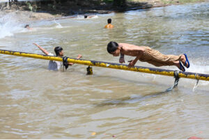 A youngster jumps into the canal and bathes to beat the scorching heat.