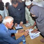 Federal Minister for Investment Board Qaiser Ahmad Sheikh listens to a woman’s complaint during an open court at his dera to address public grievances and resolve issues on the spot