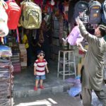 Vendor selling and displaying school bags to attract customers at G-6 Sunday Bazaar