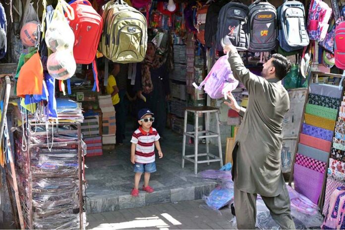 Vendor selling and displaying school bags to attract customers at G-6 Sunday Bazaar