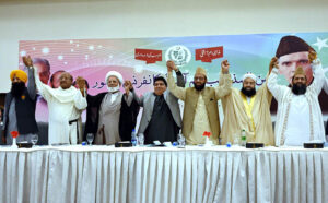 Federal Minister for Religious Affairs Sardar Muhammad Yousuf, Minister of State Kehildas Kohistani, Allama Tahir Ashrafi, Allama Azad Kabir, Provincial Minister Ramesh Singh, Allama Ghulam Muhammad Akbar, and other dignitaries express solidarity by forming a hand chain during the Interfaith Harmony Conference held at a local hotel.