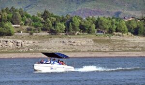 Tourists enjoy parasailing with the help of a water jet bike at Khanpur Dam, located about 50 km from Islamabad in Khyber Pakhtunkhwa
