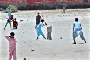 Youngsters are enjoying a cricket match at the local ground in their free time