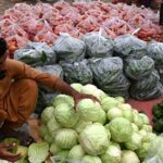 A vendor displaying fresh vegetables to attract the customers at Vegetable Market