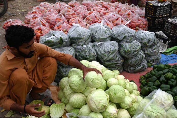 A vendor displaying fresh vegetables to attract the customers at Vegetable Market