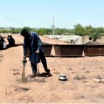 A laborer is engrossed in his routine work at a brick kiln, striving hard to earn a livelihood