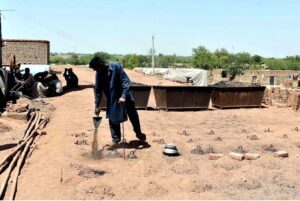A laborer is engrossed in his routine work at a brick kiln, striving hard to earn a livelihood