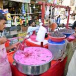 A street vendor sells chilled falsa drinks to quench the thirst of passersby under the blazing sun at Pakistan Chowk