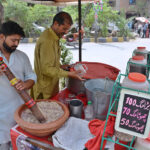A vendor skillfully prepares refreshing drink Sardai to quench summer thirst in the city