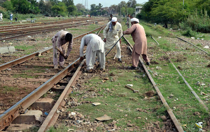 Railway workers busy in repairing a railway track near Shahdara Railway Station