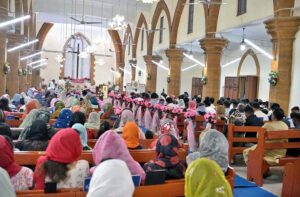 Christian community engaged in their religious rituals during Easter Sunday mass, commemorating the resurrection of Jesus as part of the Holy Week celebrations at St. Thomas Church, Civil Lines.