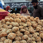 A vendor selling the traditional food item Jaggery (Gurr) to the customers outside the Dehli gate in the Provincial Capital