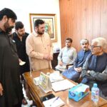 Defence Minister Khawaja Muhammad Asif listens to the problems of people during a public meeting at his residence