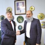 Federal Minister for Commerce Jam Kamal Khan and SPIMEX Vice President Dmitriy Chernyshev shake hands after a meeting on strengthening Pakistan-Russia trade ties